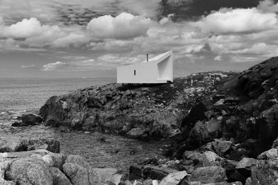 Rock formations by sea against sky