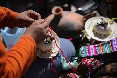 Midsection of woman making art product for sale