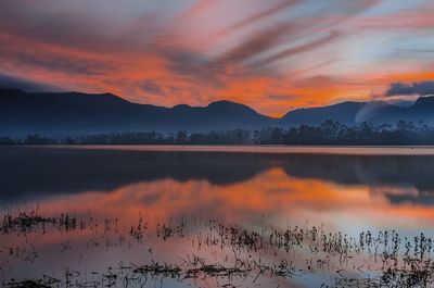 Scenic view of lake against romantic sky at sunset