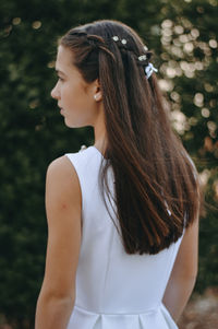 Teenage girl with long hair looking away