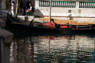 Reflection of people on boat in canal