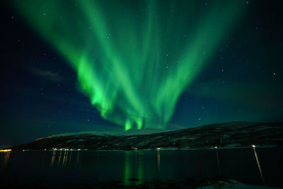 Scenic view of lake against sky at night