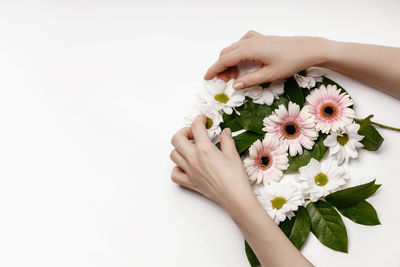 Midsection of woman hand holding white flowering plant