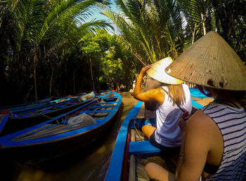 Rear view of woman working in boat