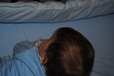 Baby boy playing in crib at home