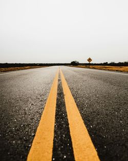 Surface level of road against clear sky