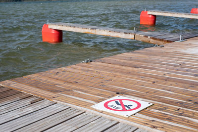 High angle view of text on pier against lake