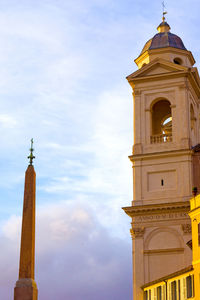 Low angle view of bell tower against cloudy sky