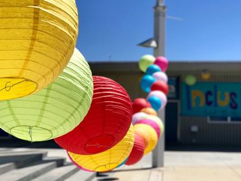 Low angle view of colorful balloons against clear sky