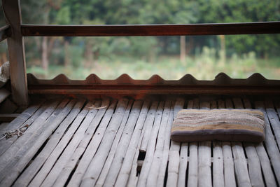 Close-up of wooden railing against building