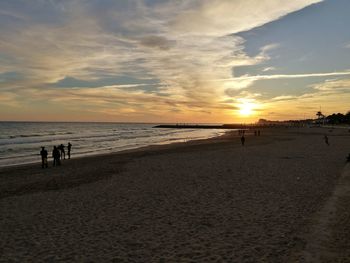Scenic view of beach against sky during sunset