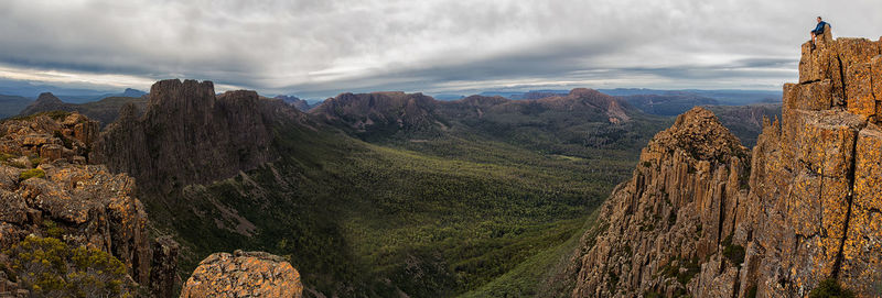 Panoramic view of rocky mountains against cloudy sky