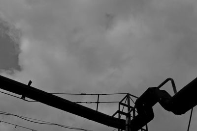 Low angle view of silhouette bird perching on tree