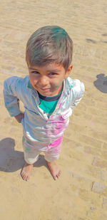 High angle view of cute boy covered in powder paint