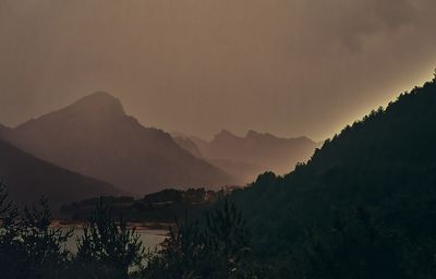 Scenic view of silhouette mountains against sky at sunset