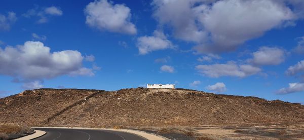 Low angle view of mountain against blue sky