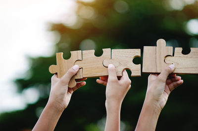 Cropped hand holding jigsaw pieces