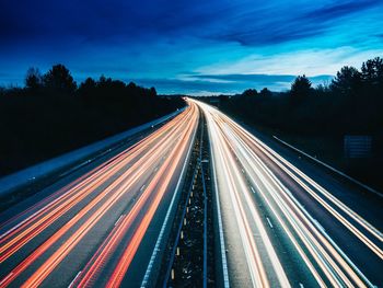 High angle view of light trails on highway at night