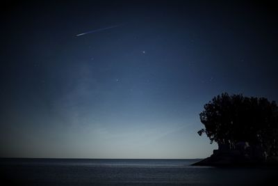 Scenic view of sea against sky at night