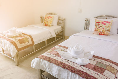 Towels arranged on beds in hotel room