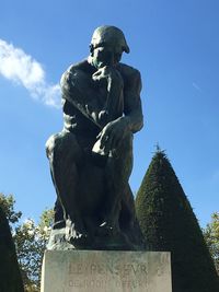 Low angle view of statue against blue sky