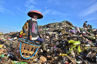 Portrait of woman with basket at scrap yard