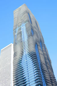 Low angle view of modern buildings against blue sky