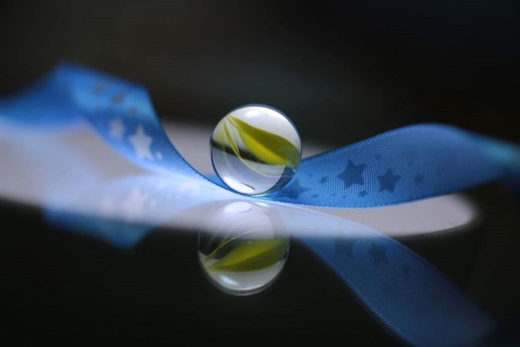 indoors, drink, table, still life, refreshment, close-up, freshness, food and drink, drinking glass, selective focus, glass - material, no people, focus on foreground, transparent, glass, studio shot, water, high angle view, yellow, liquid