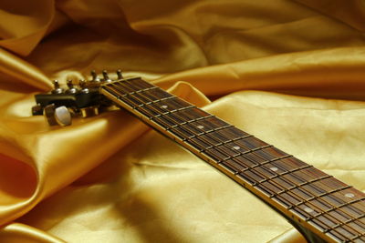 Close-up of guitar on fabric