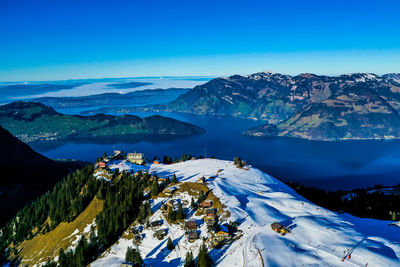 Scenic view of snowcapped mountains against blue sky