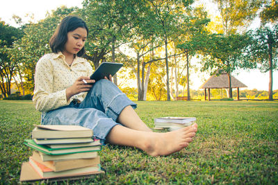 Young woman sitting on book