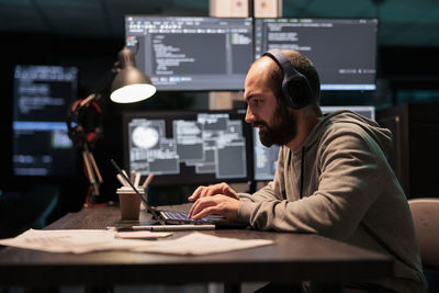 Side view of businessman working at office