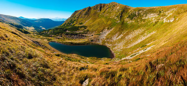 Scenic view of landscape and mountains against sky