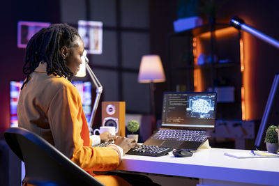 Young woman using laptop at office