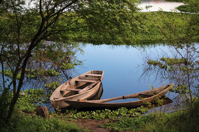 Abandoned boat moored at lakeshore