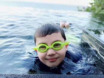 Portrait of cute boy swimming in pool