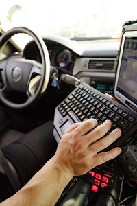 Midsection of man using laptop