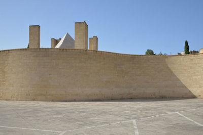 Low angle view of historical building against clear blue sky