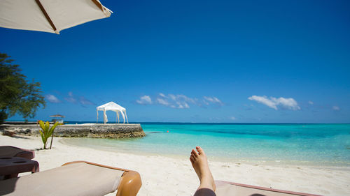 Feet relax at maldives resort paradise blue sky and turqoiuse sea