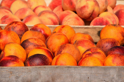Close-up of peaches in crates