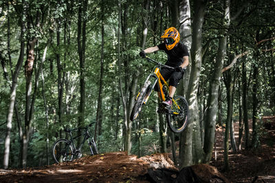 Man riding bicycle in forest