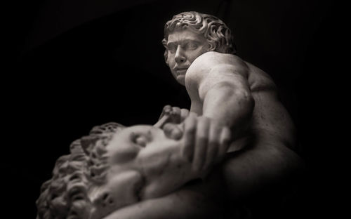 Low angle view of statue against black background