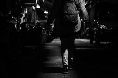 Woman standing on road at night