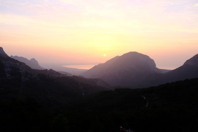 Scenic view of silhouette mountains against sky during sunset