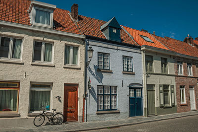 Facade of old houses in street of bruges. a town full of canals and old buildings in belgium.