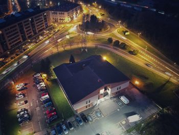 High angle view of illuminated street amidst buildings in city