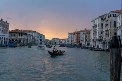 View of buildings in city at sunset