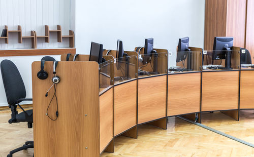 Empty chairs and tables in room