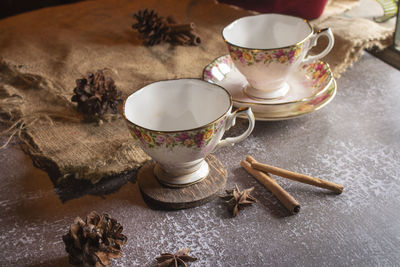 High angle view of coffee and cups on table