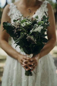 Midsection of woman holding bouquet